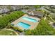 Aerial view of the community pool and clubhouse with ample seating and well-maintained landscaping at 12357 Copper Mountain Blvd, Charlotte, NC 28277