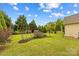 Well-maintained backyard with lush lawn and garden beds, offering a serene outdoor space at 12746 Bravington Rd, Huntersville, NC 28078
