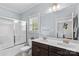 Bright bathroom with a double sink vanity, large mirror, and shower-tub combo at 12746 Bravington Rd, Huntersville, NC 28078