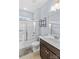 Bright bathroom featuring a shower-tub combo, light blue walls, and a modern vanity at 12746 Bravington Rd, Huntersville, NC 28078