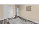 Neutral toned bedroom with gray wood floors, double door closet, and decorative mirror at 12746 Bravington Rd, Huntersville, NC 28078