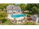 Aerial view showcasing a large backyard pool, patio, deck, and manicured lawn at 130 Hopedale Ct, Mooresville, NC 28117