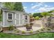 Backyard shed with an outdoor fire pit and garden area at 130 Hopedale Ct, Mooresville, NC 28117