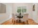 Bright breakfast nook featuring hardwood floors, four chairs, and a window with a wooded view at 130 Hopedale Ct, Mooresville, NC 28117