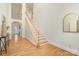 Bright entryway showcasing hardwood floors and a staircase with white railing at 130 Hopedale Ct, Mooresville, NC 28117