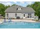 Back exterior of the home with well-maintained siding, and featuring an in-ground pool and patio at 130 Hopedale Ct, Mooresville, NC 28117