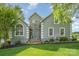 Charming two-story home with stone accents, arched windows, landscaped yard, and a welcoming entrance at 130 Hopedale Ct, Mooresville, NC 28117