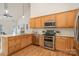 Bright kitchen featuring wood cabinets, stainless steel appliances, and hardwood floors at 130 Hopedale Ct, Mooresville, NC 28117