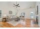 Spacious living room with hardwood floors, neutral furniture, and a vaulted ceiling at 130 Hopedale Ct, Mooresville, NC 28117