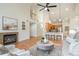 Open-concept living space showcasing a fireplace, hardwood floors, and natural light at 130 Hopedale Ct, Mooresville, NC 28117