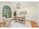 Inviting home office featuring a large window, decorative wainscoting, and hardwood floors at 130 Hopedale Ct, Mooresville, NC 28117