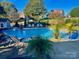 Resort-style pool with lush landscaping, lounge seating, and serene backyard views at 130 Hopedale Ct, Mooresville, NC 28117