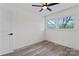 Empty bedroom with ceiling fan, window, and door leading to hallway at 1341 Hopewell Rd, Rock Hill, SC 29730