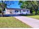 Charming single-story home featuring a white exterior, covered parking, and a spacious front yard with a concrete driveway at 1341 Hopewell Rd, Rock Hill, SC 29730