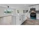 Open kitchen featuring white cabinets, stainless appliances, a center island with quartz countertop, and an adjacent living area at 1341 Hopewell Rd, Rock Hill, SC 29730