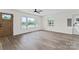 Bright living room with multiple windows and wood-look flooring and a natural wood front door at 1341 Hopewell Rd, Rock Hill, SC 29730