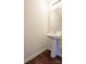 Pedestal sink and a decorative mirror in a compact half-bathroom at 1430 Eastway Dr, Dallas, NC 28034