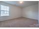 Empty bedroom with a large window and neutral carpeting at 1430 Eastway Dr, Dallas, NC 28034