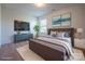 Staged bedroom featuring a queen-sized bed, TV, plants, and a large window at 1430 Eastway Dr, Dallas, NC 28034