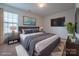 Staged bedroom featuring a queen-sized bed, two side tables, and a wall-mounted TV at 1430 Eastway Dr, Dallas, NC 28034