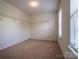 Walk in closet featuring carpet flooring and a single window at 1430 Eastway Dr, Dallas, NC 28034