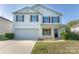 Traditional two-story home features a 2-car garage, neutral siding, and a well-maintained yard at 1430 Eastway Dr, Dallas, NC 28034