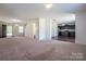 Open-concept floor plan featuring a carpeted living room and an adjacent kitchen at 1430 Eastway Dr, Dallas, NC 28034