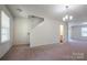 Carpeted living area with a staircase and a view into the adjacent bathroom at 1430 Eastway Dr, Dallas, NC 28034
