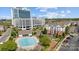 View of condos and community pool on a sunny day with parking and sidewalks at 14869 Santa Lucia Dr, Charlotte, NC 28277