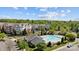 View of condos and community pool surrounded by trees and parking on a sunny day at 14869 Santa Lucia Dr, Charlotte, NC 28277