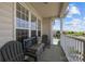 Relaxing balcony with cushioned bench and chairs overlooking a swimming pool at 14869 Santa Lucia Dr, Charlotte, NC 28277