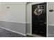Apartment door with wreath, gold hardware, house number, and light fixture in a neutral hallway at 14869 Santa Lucia Dr, Charlotte, NC 28277