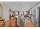 Open concept kitchen with stainless appliances, granite counters, and seamless flow to the living area at 14869 Santa Lucia Dr, Charlotte, NC 28277