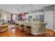 Charming kitchen features granite counters, stainless appliances, and seating at the center island at 14869 Santa Lucia Dr, Charlotte, NC 28277