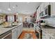 Well-appointed kitchen with stainless appliances and granite countertops that opens to dining area at 14869 Santa Lucia Dr, Charlotte, NC 28277