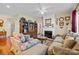 Bright living room offers a fireplace, hardwood floors, ceiling fan, and classic design at 14869 Santa Lucia Dr, Charlotte, NC 28277