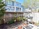 Cozy backyard featuring a seating area, privacy fence, and garden beds with flowers and plants at 1568 Cleveland Ave, Charlotte, NC 28203