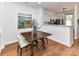 Dining area adjacent to the kitchen features a wooden table and chairs, complemented by a colorful painting at 1568 Cleveland Ave, Charlotte, NC 28203