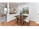 Dining area with hardwood floors, a wooden table, and a view into the living room, ideal for Gathering meals and gatherings at 1568 Cleveland Ave, Charlotte, NC 28203