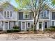 Charming townhomes featuring gray siding, white trim, and well-maintained landscaping, offering a welcoming curb appeal at 1568 Cleveland Ave, Charlotte, NC 28203