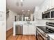 Spacious kitchen with stainless steel appliances, white countertops, and a view into the dining area, perfect for entertaining at 1568 Cleveland Ave, Charlotte, NC 28203