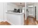 Well-lit kitchen with white cabinets, stainless steel appliances, and breakfast bar, creating a modern and functional space at 1568 Cleveland Ave, Charlotte, NC 28203