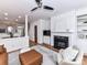 Open living room with decorative fireplace, view of dining area, hardwood floors and lots of light at 1568 Cleveland Ave, Charlotte, NC 28203