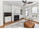 Bright living room features fireplace, ceiling fan, and door to the outside with plenty of natural light at 1568 Cleveland Ave, Charlotte, NC 28203
