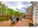 Cozy back deck with comfortable seating and a view of lush green trees at 1588 Trentwood Dr, Fort Mill, SC 29715