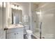Bright bathroom featuring a vanity with drawers, a toilet, and glass shower at 1588 Trentwood Dr, Fort Mill, SC 29715