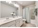 Bathroom featuring double vanity sinks, shower over tub, and neutral tile flooring at 1588 Trentwood Dr, Fort Mill, SC 29715
