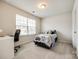 Bright bedroom with a study desk, chair, and carpeted floor at 1588 Trentwood Dr, Fort Mill, SC 29715