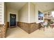 Covered front porch with brick detailing, neutral siding, and a welcoming front door with wreath at 1588 Trentwood Dr, Fort Mill, SC 29715