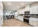 Open floor plan showcasing the modern kitchen with stainless steel appliances and an adjacent dining area at 1588 Trentwood Dr, Fort Mill, SC 29715